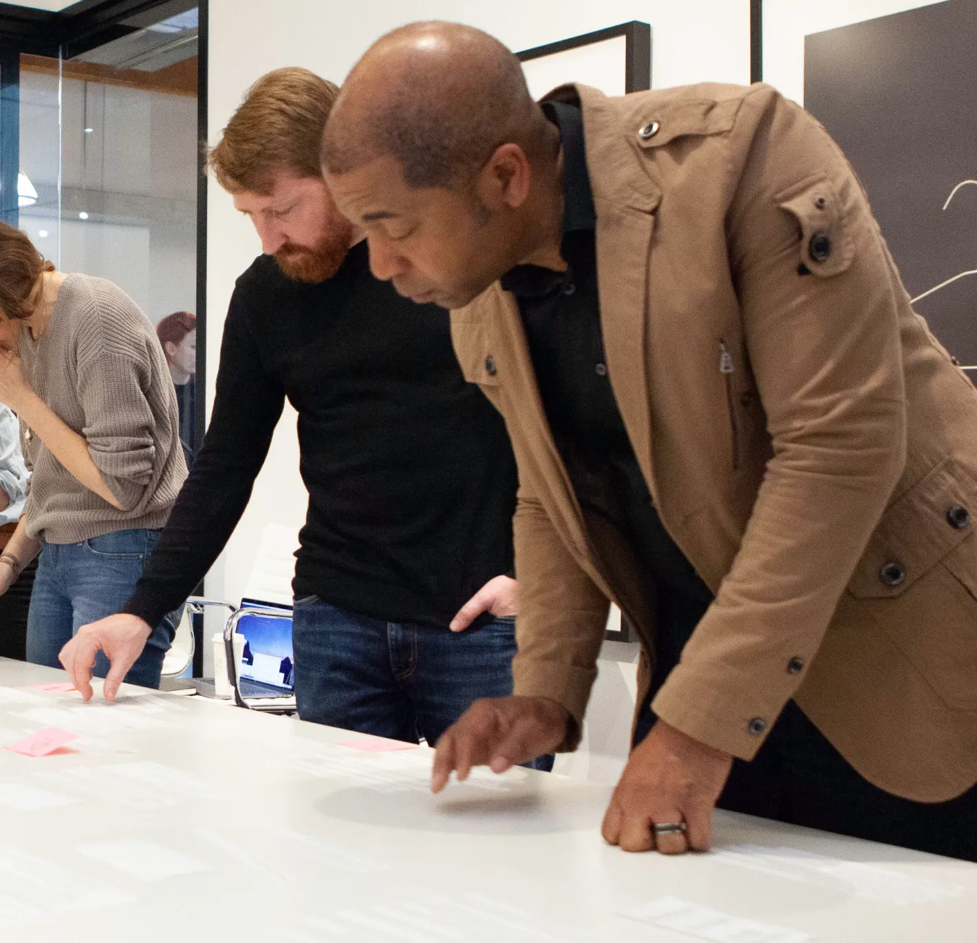 A group of people discussion research, while looking a table.