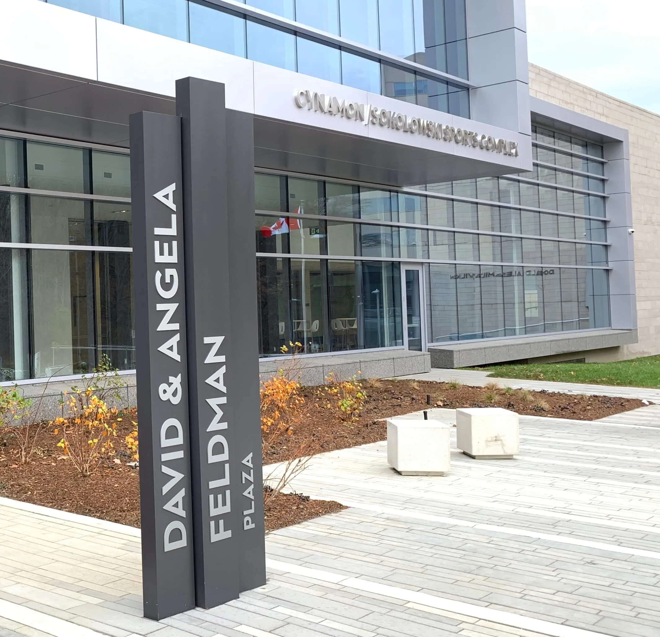 Wayfinding signage pillars outside the building.