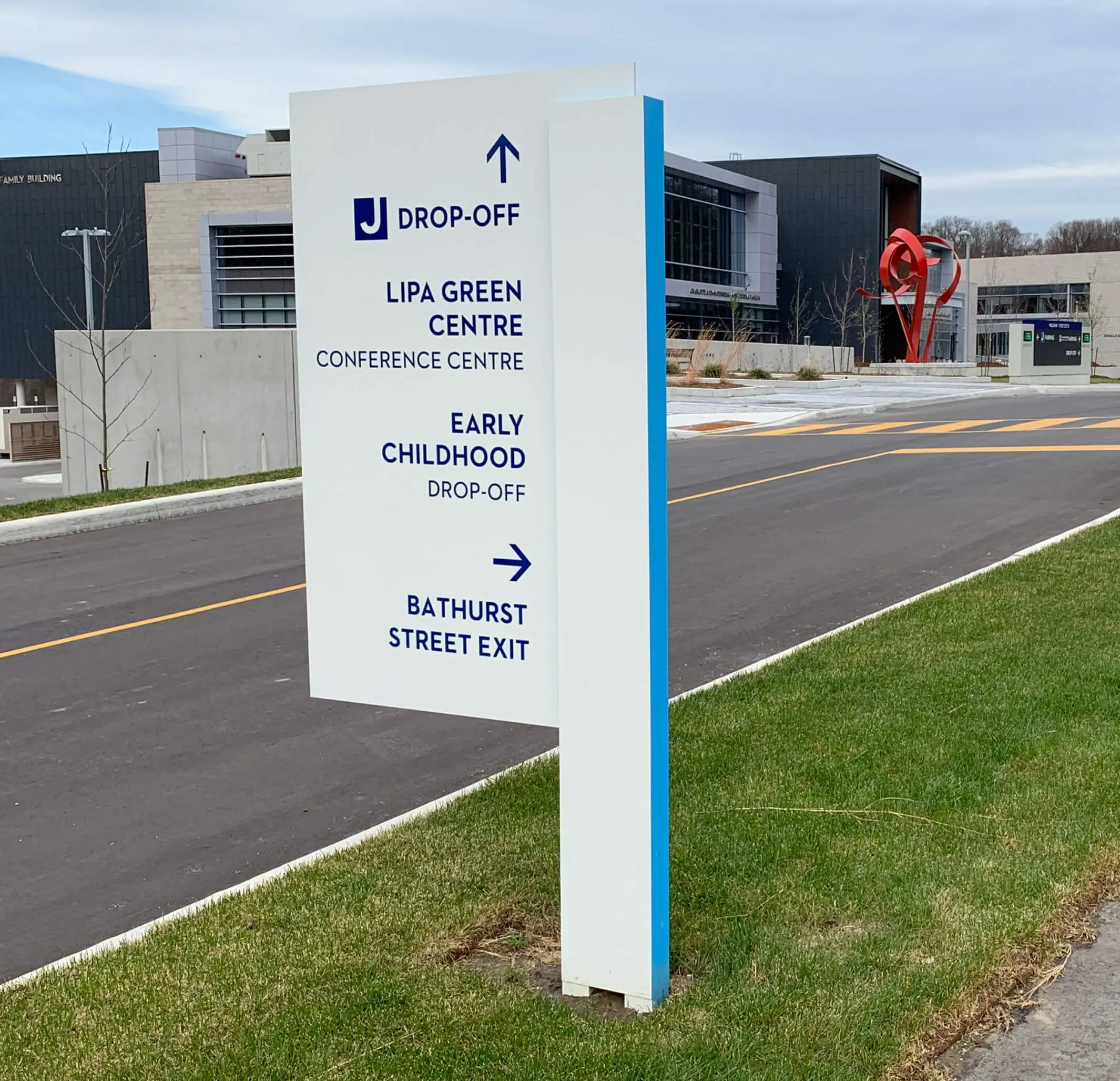 Wayfinding signage outside the building complex.